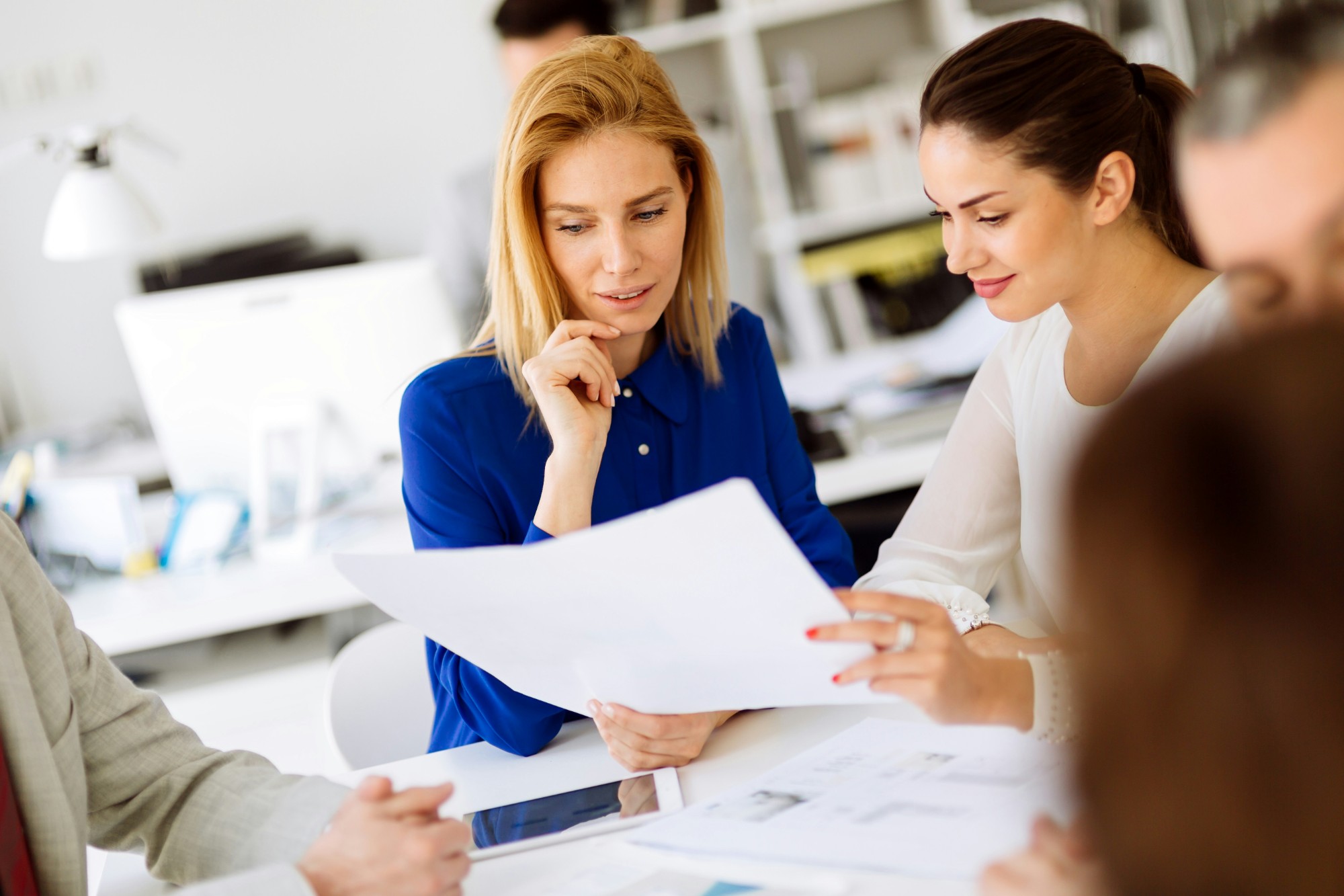 Colleagues reviewing documents together at a table